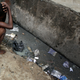 A Nigerian child squats by an open sewer in the neighbourhood of Isale-Eko in central Lagos, April 14, 2007. With unrivalled funds and powers of incumbency, analysts say Nigeria's People's Democratic Party should coast to victory in elections that began in Africa's most populous nation on Saturday. But endemic corruption, failure to deliver basic services and deteriorating security have boosted the chances of the opposition in many states. REUTERS/Finbarr O'Reilly